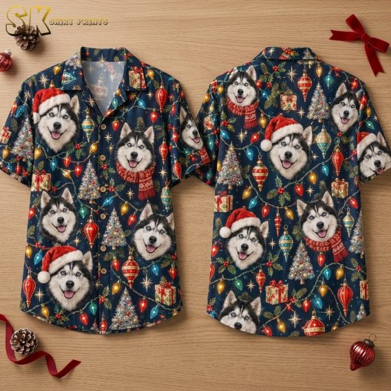 Front and back of a navy button-up shirt laid flat on a wood surface, showing an all-over pattern of realistic husky faces in Santa hats and red scarves surrounded by Christmas ornaments, string lights, and decorated trees.