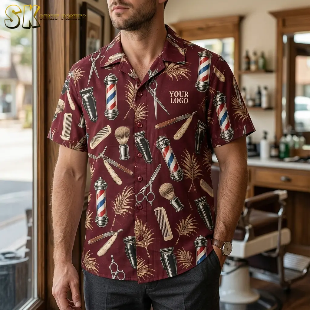A man wearing a maroon logo hawaiian shirt printed with barber poles, straight razors, and hair clippers stands inside a traditional barbershop with wooden fixtures visible behind him.