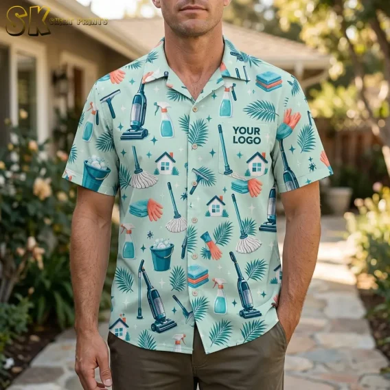 A man stands on a stone garden path wearing a mint green logo Hawaiian shirt covered in vacuum cleaners, spray bottles, and tropical leaves, with 'YOUR LOGO' printed on the left chest.