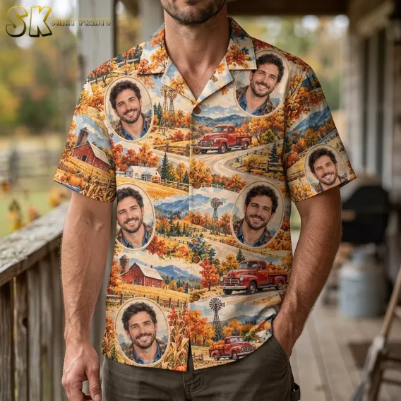 A man stands on a porch wearing a short-sleeve autumn-print shirt with oval portraits, red barns, and vintage red pickup trucks.