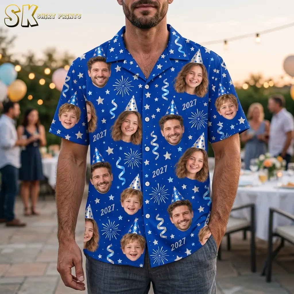 A man wears a blue family New Year's shirt with smiling face prints and 2027 text at an outdoor gathering.