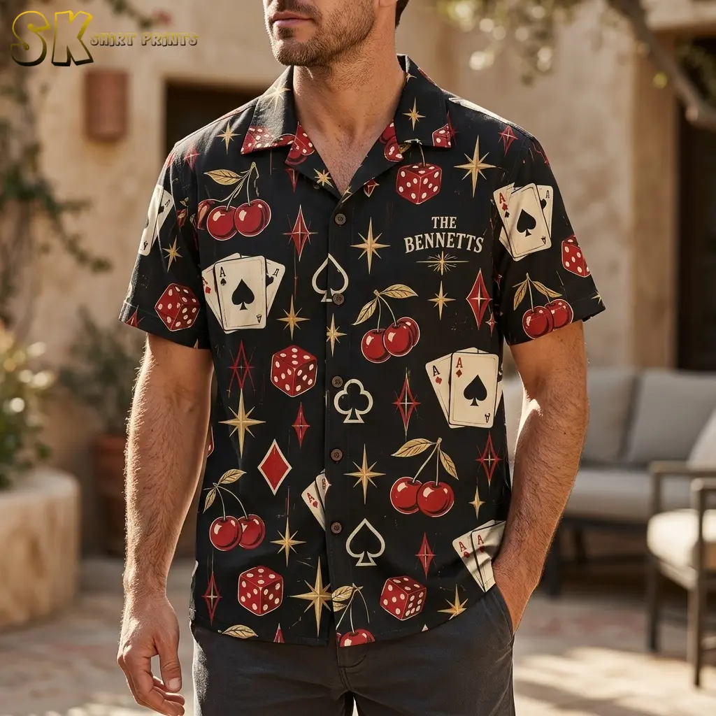 A man stands on an outdoor patio wearing a black casino-print button-up shirt with “THE BENNETTS” on the chest.