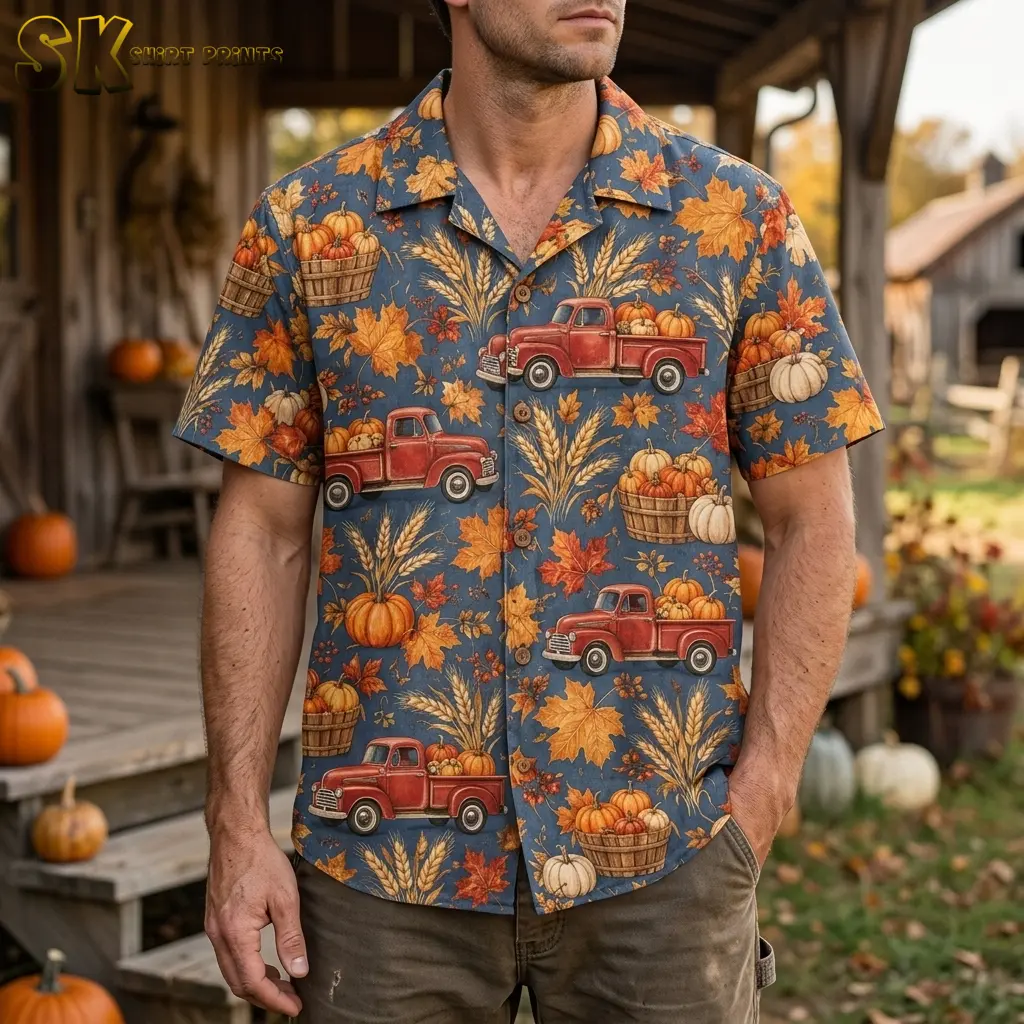 A man wears a Thanksgiving Hawaiian shirt with red pumpkin trucks on a wooden porch surrounded by pumpkins.