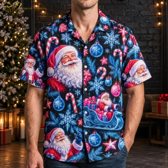 A man wears a black Santa Claus Hawaiian shirt beside a lit Christmas tree, with a large Santa portrait across the chest.