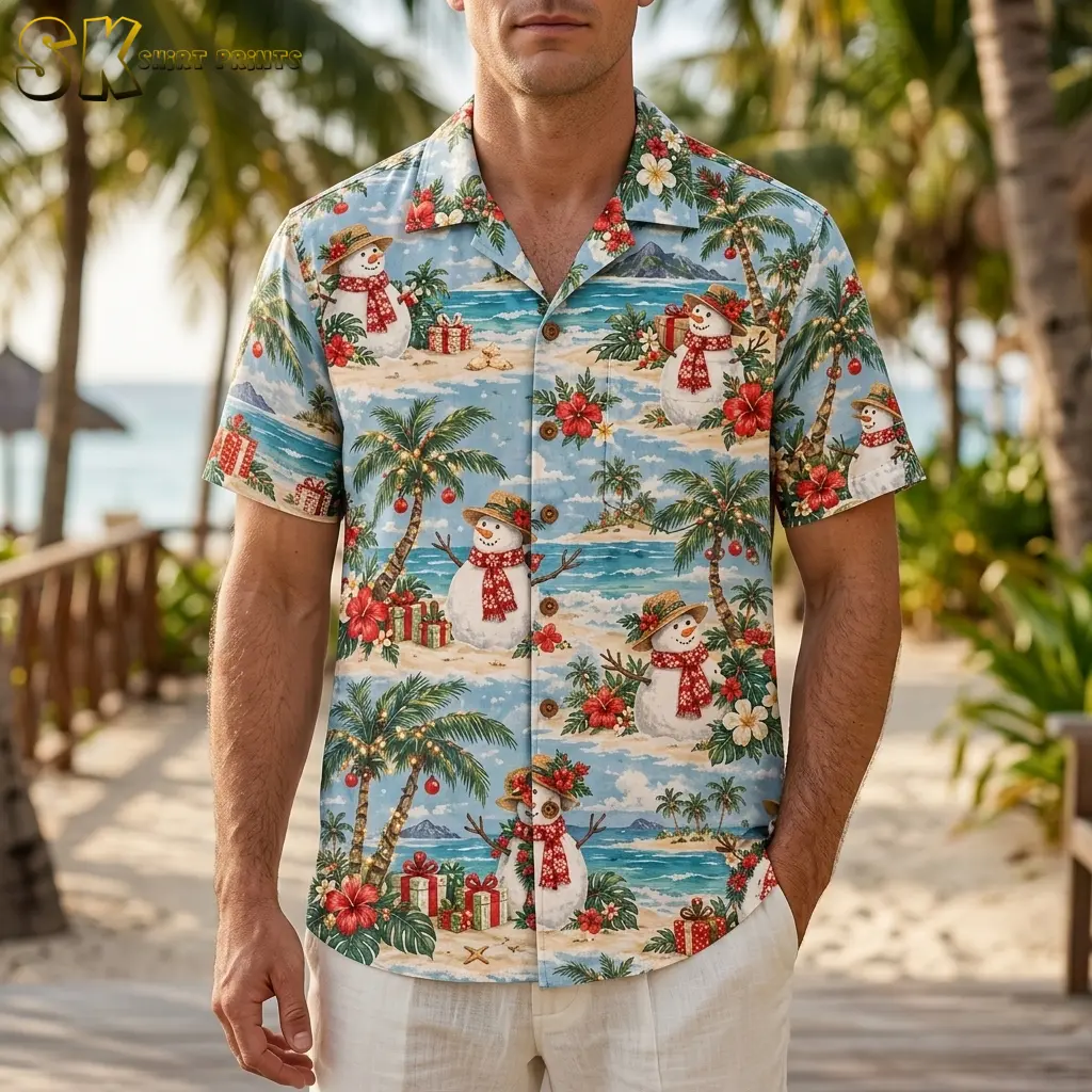 A man wears a light blue Christmas Hawaiian shirt with snowmen and palm trees on a wooden walkway near the beach.