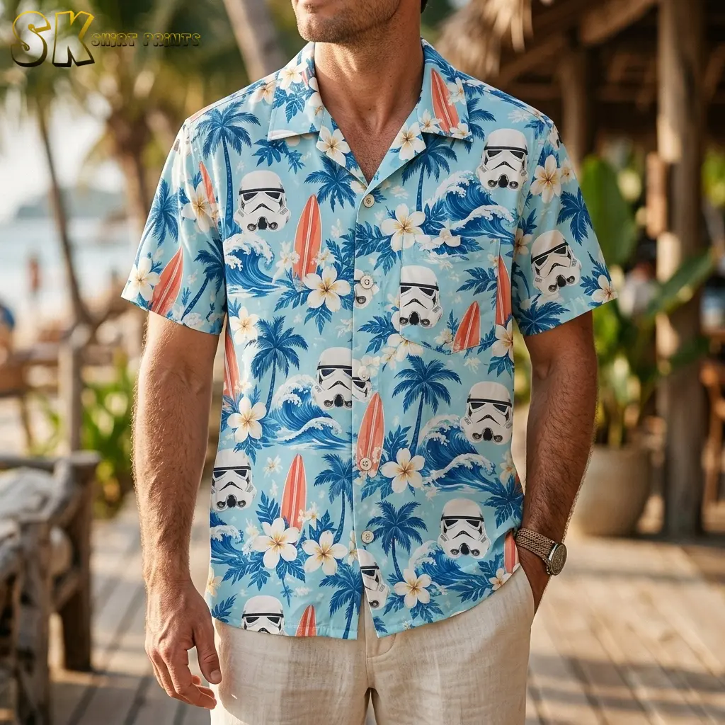 A man wears a light blue Star Wars Hawaiian shirt with stormtrooper helmets and blue waves on a wooden deck.
