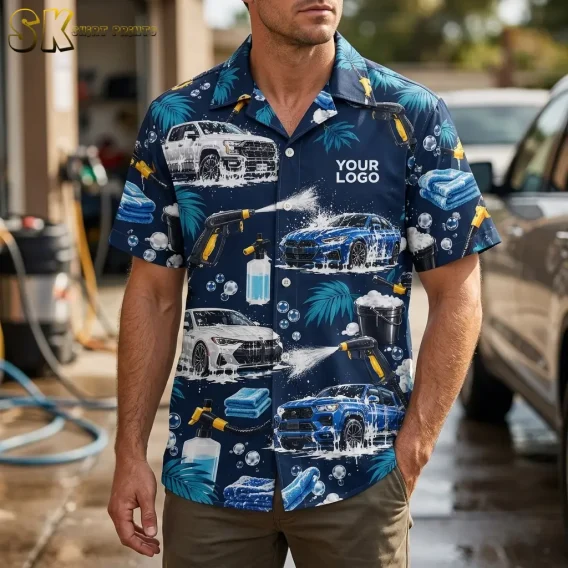 A man stands at an outdoor car wash bay wearing a custom logo hawaiian shirt printed with soapy cars, yellow spray guns, and palm leaves, with the 'YOUR LOGO' chest placement clearly visible.