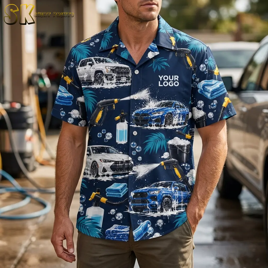 A man stands at an outdoor car wash bay wearing a custom logo hawaiian shirt printed with soapy cars, yellow spray guns, and palm leaves, with the 'YOUR LOGO' chest placement clearly visible.
