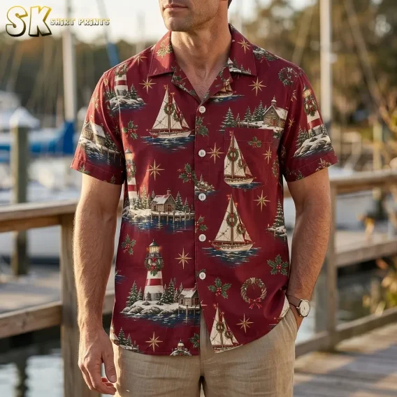 A man standing on a wooden dock at a marina wears the hawaiian christmas shirt mens style, with sailboats decorated with wreaths and a red-and-white lighthouse clearly visible across the chest.