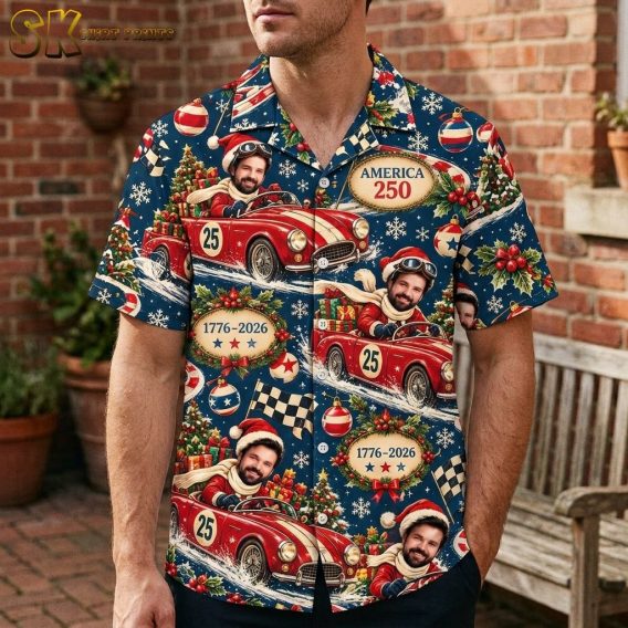 A man wearing the dark blue button-up shirt stands outdoors against a brick wall, showing how the vintage red race car and holiday motifs sit across the chest and torso.