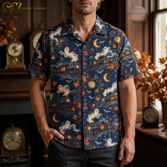 Man wearing a navy mens halloween hawaiian shirt featuring vintage steam locomotives, ghost smoke figures, crescent moons, and scattered autumn leaves.