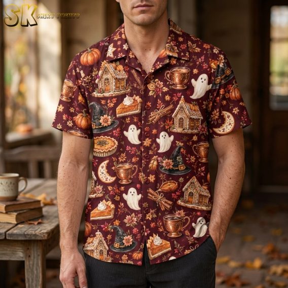 Man wearing a burgundy mens halloween hawaiian shirt printed with gingerbread houses, ghosts, witch hats, and autumn dessert motifs.