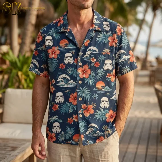A man standing outdoors at a beach resort wearing a men's star wars hawaiian shirt, with the chest pocket and button placket clearly visible against the navy background.