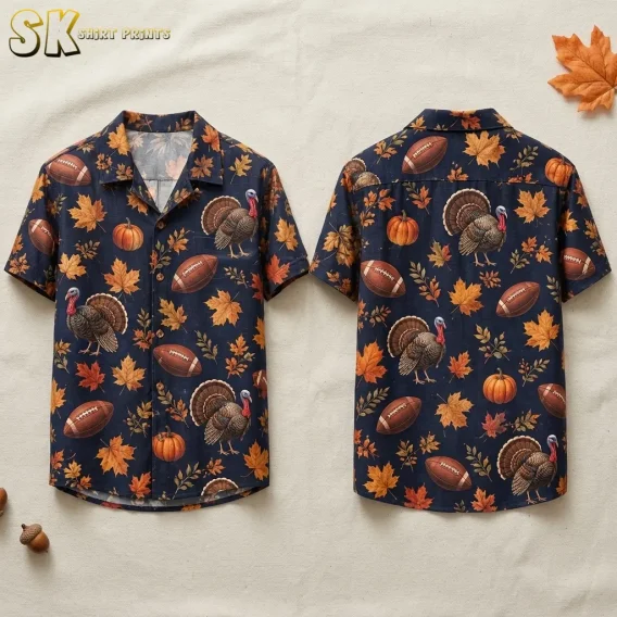 Front and back of a navy short-sleeve shirt displayed on a light surface, with turkeys, footballs, pumpkins, and fall leaves.