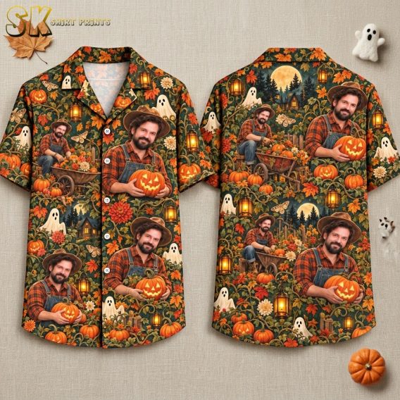 Front and back hanger view of a dark green short-sleeve button-up shirt with an all-over print featuring a man holding a jack-o'-lantern, pumpkins, ghosts, moths, flowers, and a moonlit forest cabin.