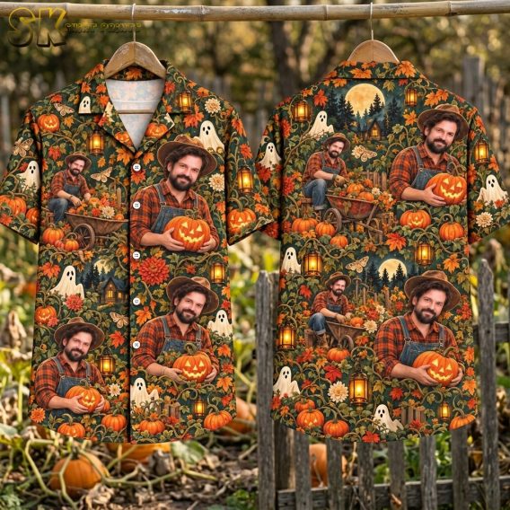 Flat lay of the dark green halloween themed hawaiian shirt showing the front and back panels side by side, with the full repeating pattern of pumpkin scenes, ghost figures, lanterns, autumn leaves, and a moonlit cabin clearly visible.