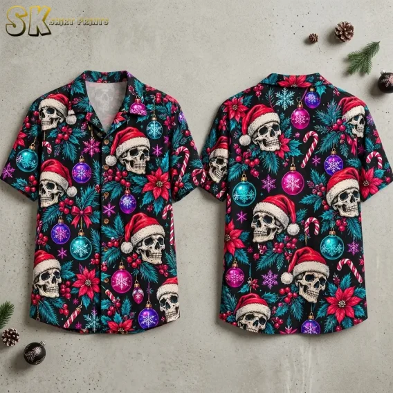 Front and back of a black Christmas themed Hawaiian shirt laid on a gray surface, featuring skulls in Santa hats and colorful ornaments.