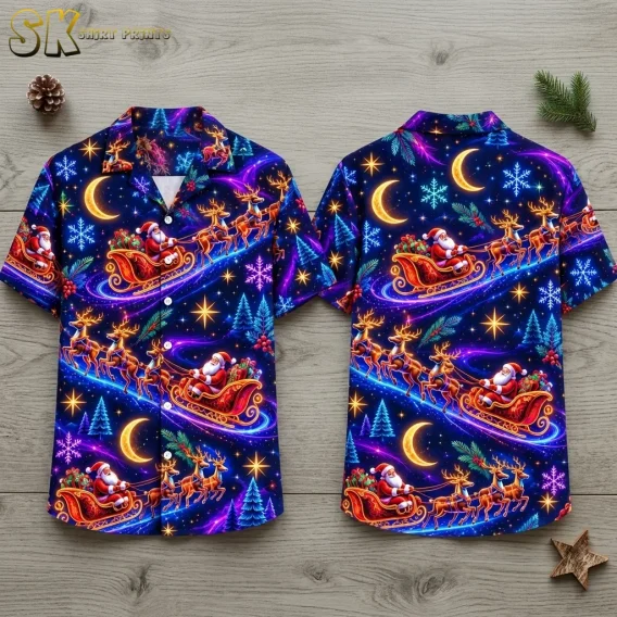 Front and back of a navy Christmas shirt lie flat on a wood surface, showing colorful Santa sleigh scenes and crescent moons.