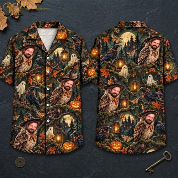 Front and back hanger view of a short-sleeve button-up shirt with an all-over dark green and black night forest print featuring owls with a man's face, glowing jack-o'-lanterns, a haunted mansion under a full moon, and orange autumn leaves.