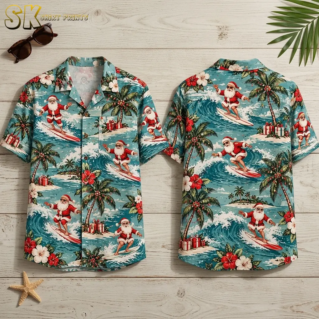 Front and back of a turquoise Santa Hawaiian shirt lie on pale wood, showing surfing Santas among waves and palm trees.
