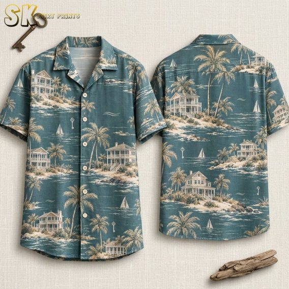 Both the front and back of a teal Hawaiian shirt are laid flat, showing the all-over coastal print of Victorian beach houses, leaning palm trees, sailboats, and small floating keys in beige and cream tones.