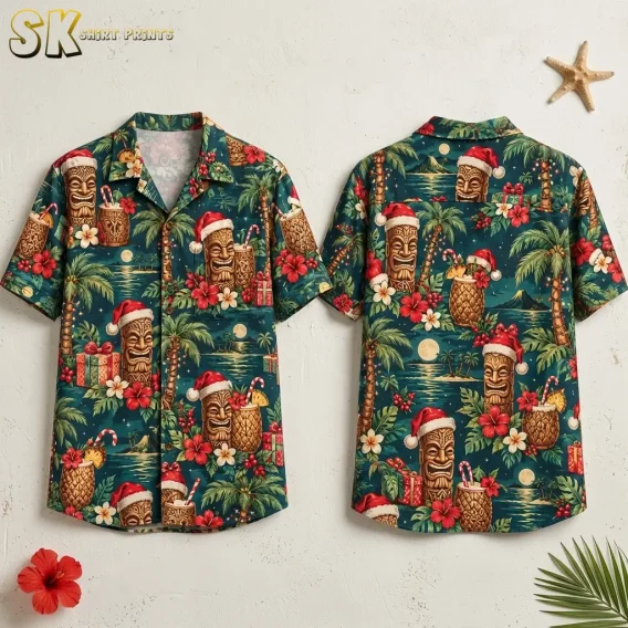 Front and back of a teal Christmas themed Hawaiian shirt with Santa-hat tiki figures, tropical drinks, and flowers against a light background.