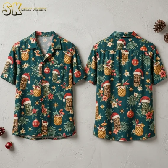 Front and back of a christmas hawaiian shirt displayed flat against a white surface, showing tiki faces in Santa hats, pineapple cocktails, hibiscus blooms, and red Christmas ornaments on a deep teal background.