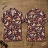 Front and back hanger view of a short-sleeve button-up shirt with a dark purplish-brown base, featuring an all-over pattern of carousel horses, striped circus tents, and smiling ghosts alongside jack-o'-lanterns and crescent moons.