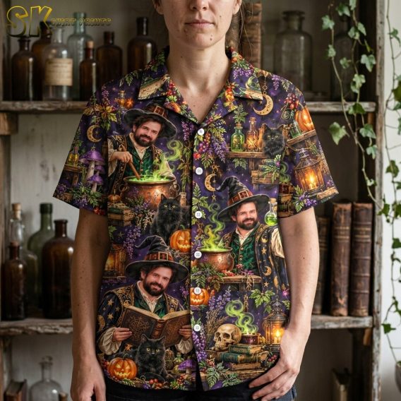 Close-up view of a woman wearing the dark purple shirt, highlighting the detailed painterly illustrations of the bearded wizard, skulls, purple mushrooms, and potion bottles in the all-over print.