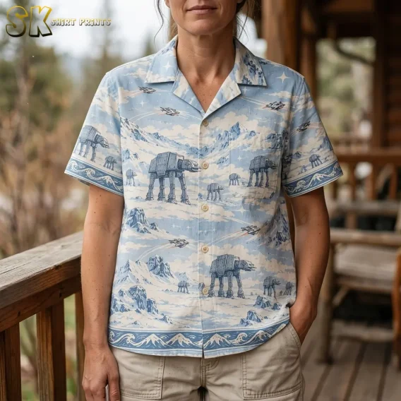 A woman wears a light blue Star Wars Hawaiian button-up shirt with beige pants, showing the camp collar, chest pocket, and snowy walker print.