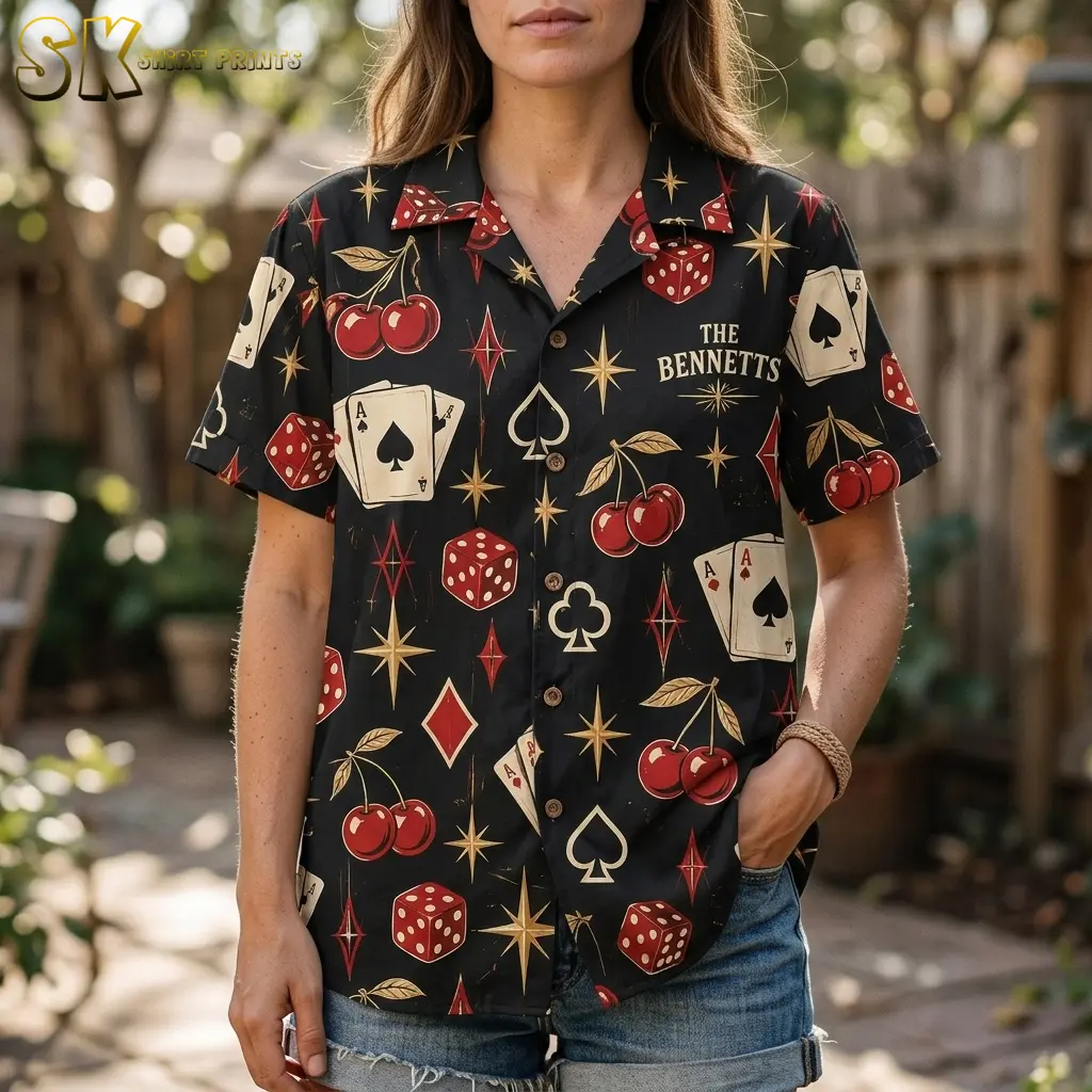 A woman wears the black casino-print shirt with denim shorts, showing the camp collar, front buttons, and “THE BENNETTS” chest text.