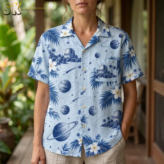 A woman wears the light blue celestial print shirt, with the collar, front buttons, and observatory-patterned chest pocket clearly visible.