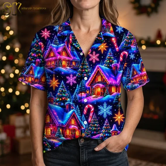 A woman wears a navy Christmas-print shirt with a pointed collar, white buttons, and large candy cane and snowy cottage illustrations.