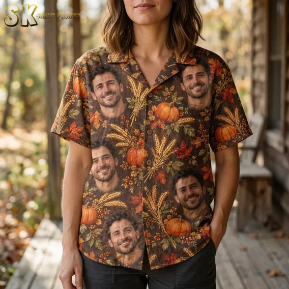 A woman wears a brown Thanksgiving button-up shirt on a porch, with large smiling face motifs and wheat stalks across the front.