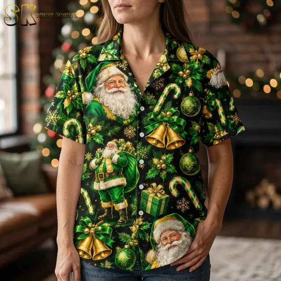 A woman wears a black Hawaiian shirt with Santa Claus in green, shown close up with gold bells and green ornaments.