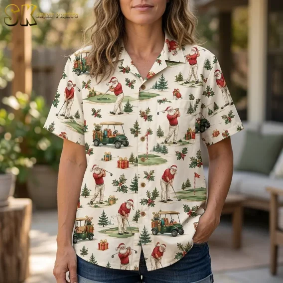 A woman wears a cream Santa golf-print shirt with denim shorts, showing the collar, buttons, and chest pocket in close-up.