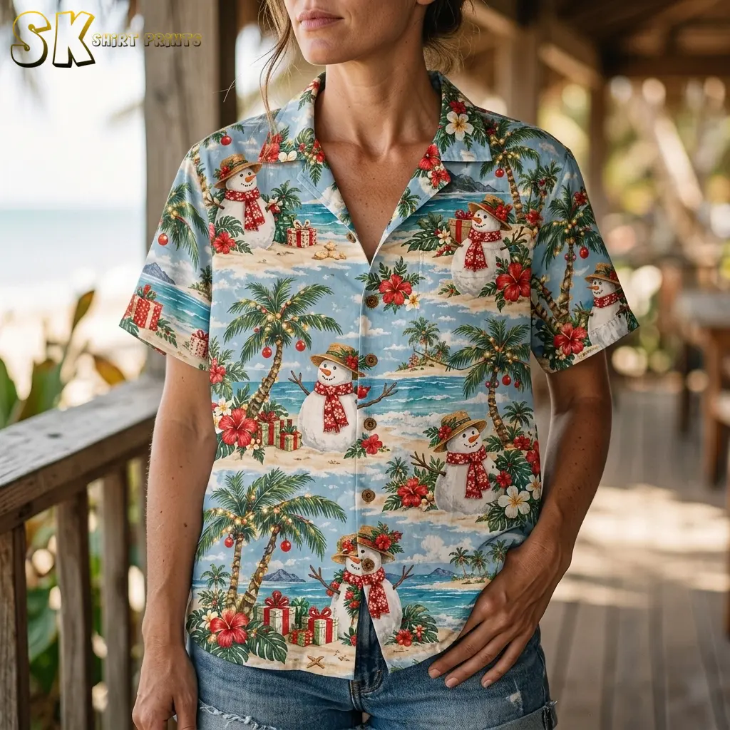 A woman wears a light blue snowman-print Hawaiian shirt with denim shorts, showing the collar and button front up close.