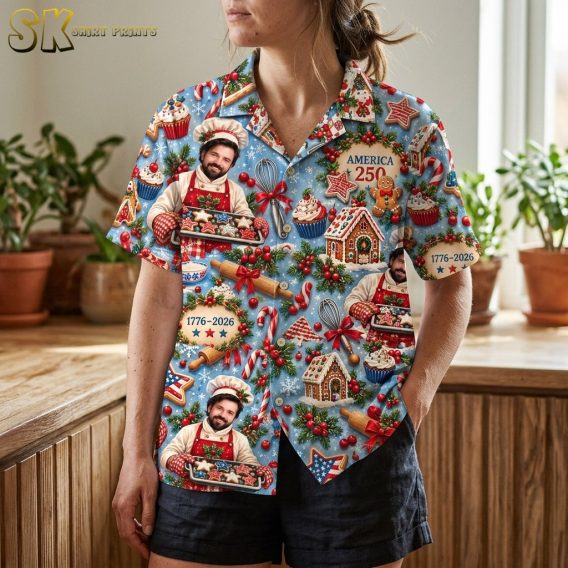 A woman wearing the shirt is photographed from the torso down, bringing the rolling pin, candy cane, gingerbread house, and '1776–2026' wreath motifs into sharp focus across the front panels.