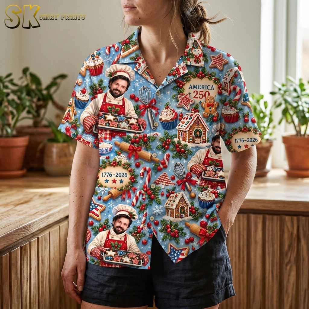 A woman wearing the shirt is photographed from the torso down, bringing the rolling pin, candy cane, gingerbread house, and '1776–2026' wreath motifs into sharp focus across the front panels.