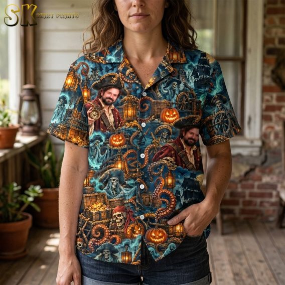 A woman wearing the spooky hawaiian shirt stands on a wooden porch, with the upper-body close-up highlighting the bearded pirate portrait, glowing pumpkins, and curling orange octopus tentacles printed across the chest and shoulders.
