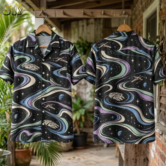 Two black Star Wars Hawaiian shirts hang front and back from a wooden rack, displaying spacecraft and pastel swirls beside greenery and brickwork.