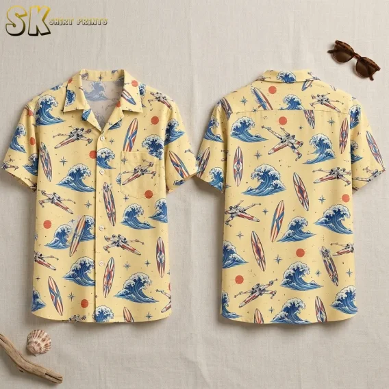 A pale yellow short-sleeve shirt is displayed front and back with blue waves, surfboards, and spacecraft across the fabric.